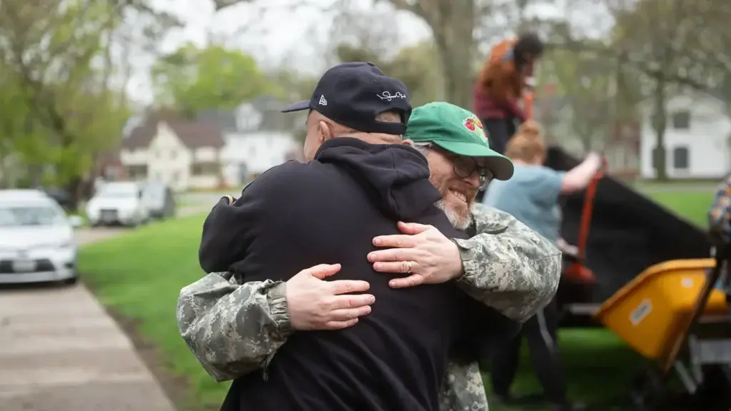 RAID members embrace at the memorial garden