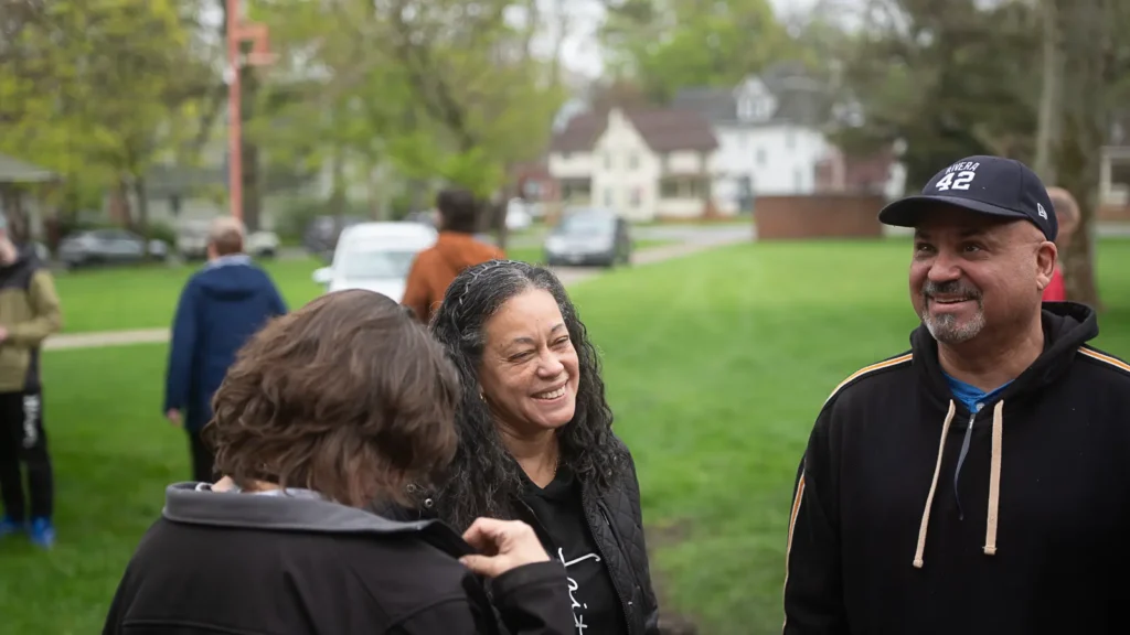 A RAID member smiles at the memorial garden planting